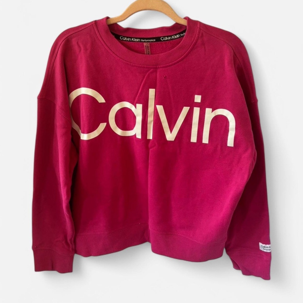 Pink Calvin Klein performance sweater 
Size: Medium
Small hole (pictured)